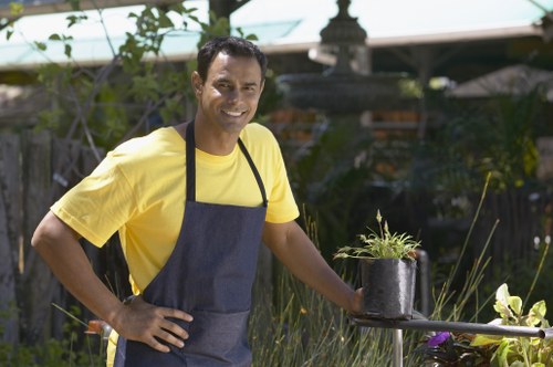 Community gardener preparing soil in an Enfield garden plot
